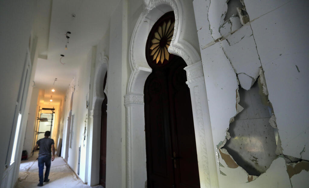 A worker walks in a corridor of the Sursock Museum that is still under reconstruction a year after being damaged in the massive explosion at the nearby port, in Beirut
