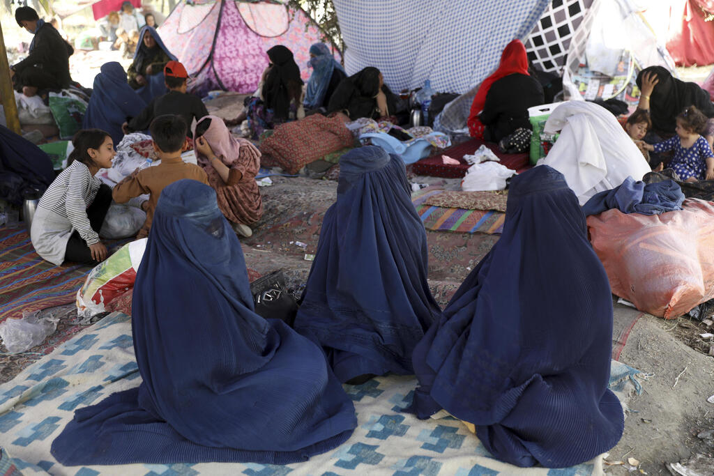 Refugees from Taliban-controlled areas sleep in a park in Kabul 