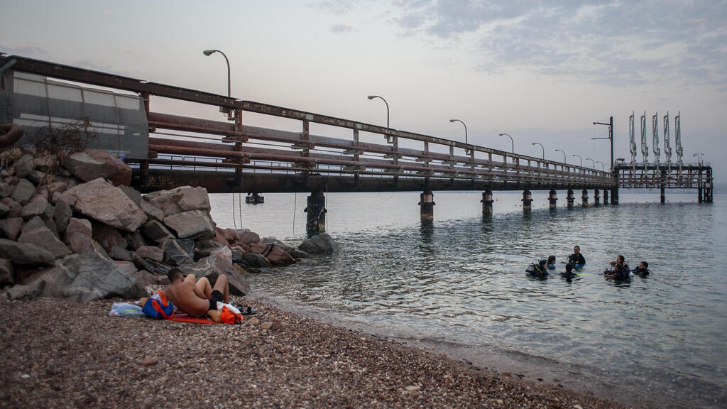 A group of scuba divers prepares to exit the water after diving in the Red Sea near t the Europe-Asia Pipeline Company (EAPC) oil jetty in Israel's southern city of Eilat, Thursday, Aug, 5. 2021 