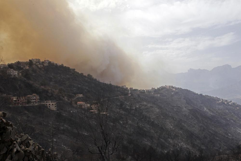 Smoke and fires threaten a village near Tizi Ouzou some 100 km (62 miles) east of Algiers following wildfires in this mountainous region 