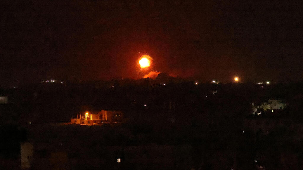 A fireball rises following an air strike in Khan Yunis in the southern Gaza Strip, late on August 23, 2021