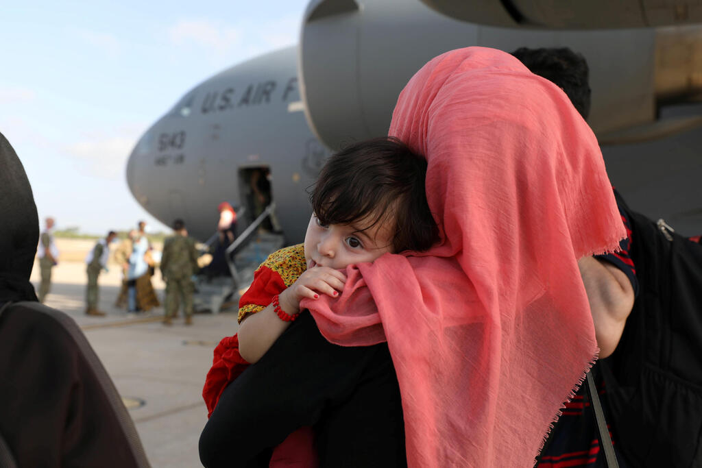 Afghan woman and her child arrive at Kuwait airport after being airlifted out of Afghanistan after Taliban takeover, August 28, 2021 
