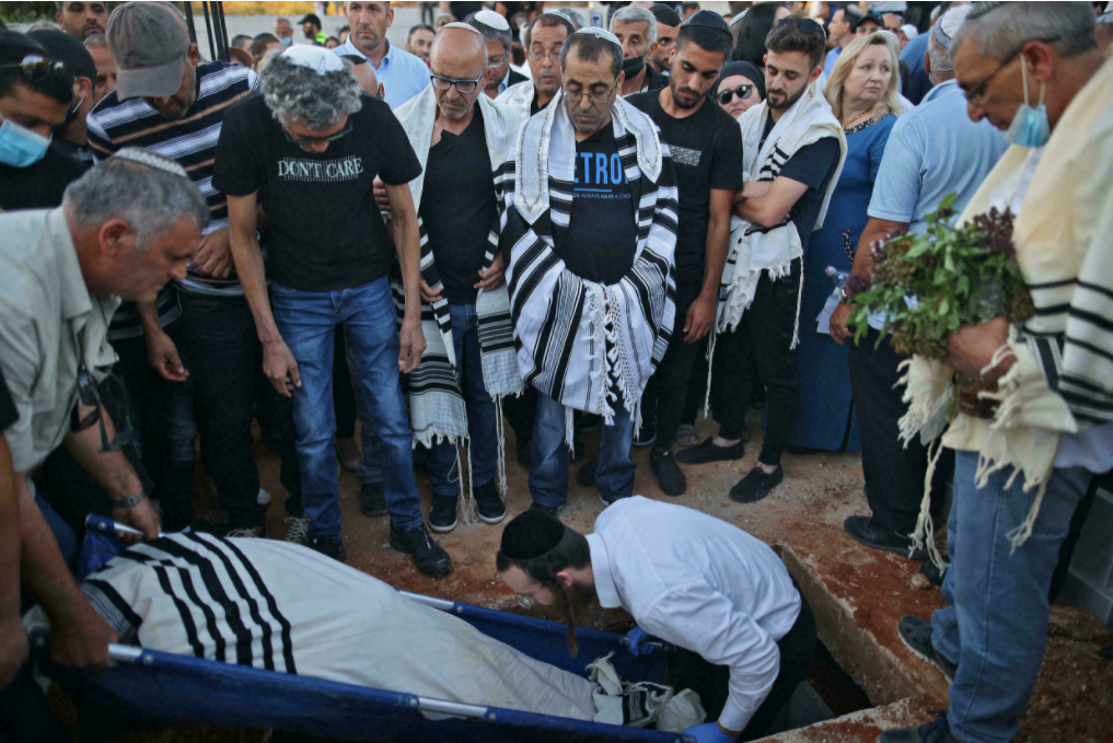 Israeli mourners attend the funeral of Yigal Yehoshua in the city of Modiin on May 18