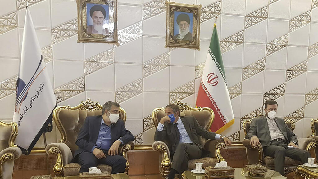 Director General of International Atomic Energy Agency, IAEA, Rafael Mariano Grossi, center, speaks with Deputy Head of the Atomic Energy Organization of Iran, Behrouz Kamalvandi, left, upon his arrival at Tehran
