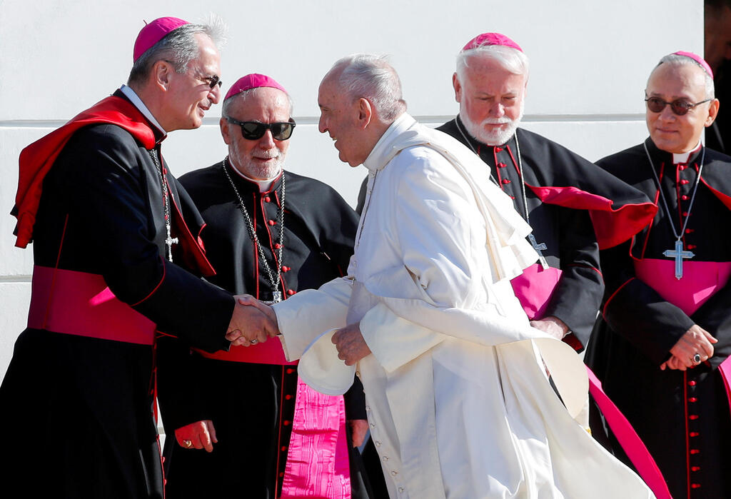 Pope Francis shakes hands with Archbishop of Bratislava Stanislav Zvolensky