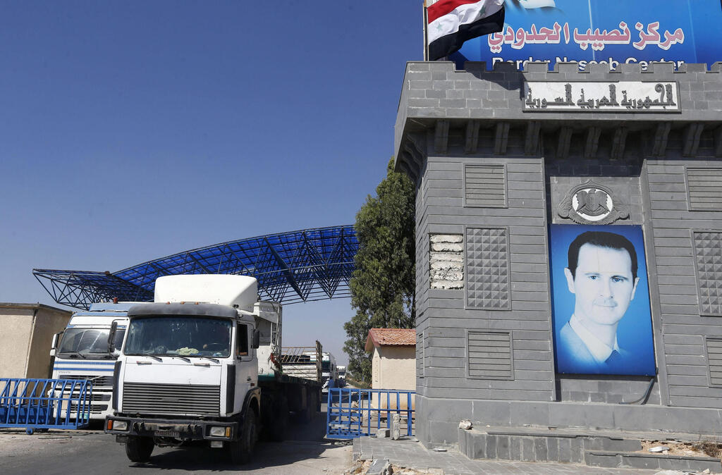 Trucks enter Syria through the Nassib/Jaber border post with Jordan on the day of its reopening, on September 29, 2021, after two months of closure due to fighting in southern Syria 