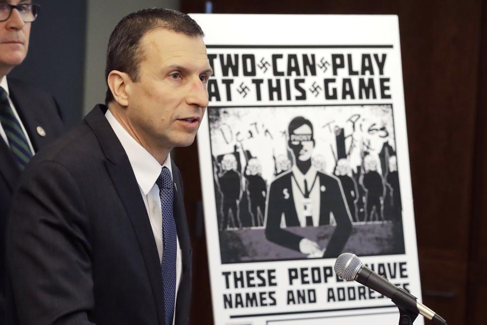 Raymond Duda, special agent in charge in Seattle, speaks as he stands next to a poster that was mailed earlier in the year to the home of Chris Ingalls, an investigative reporter with KING-TV in Seattle, during a news conference 