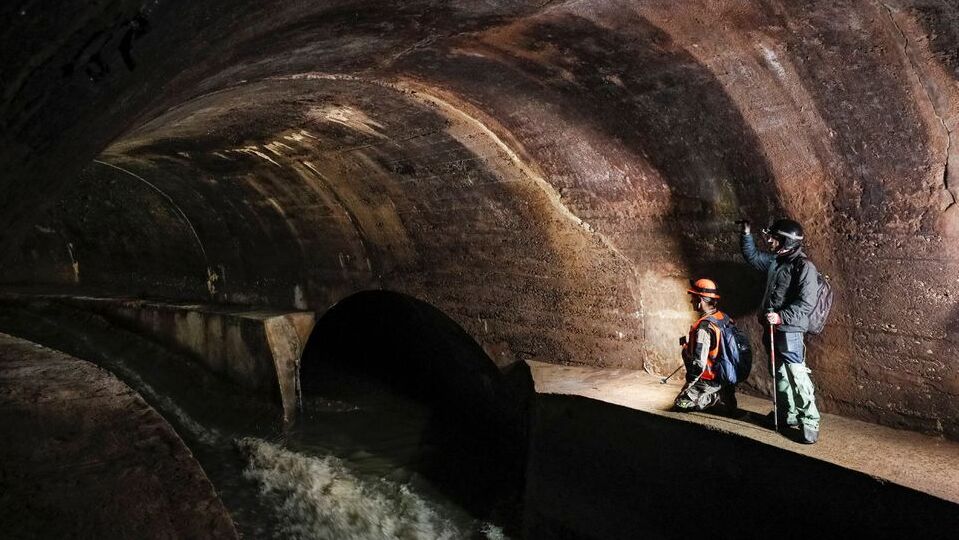 Diggers Andriy Ryshtun and Oleksandr Ivanov explore the city sewage system where dozens of Jews were hiding from the Nazis during World War Two in Lviv, Ukraine September 25, 2021.
