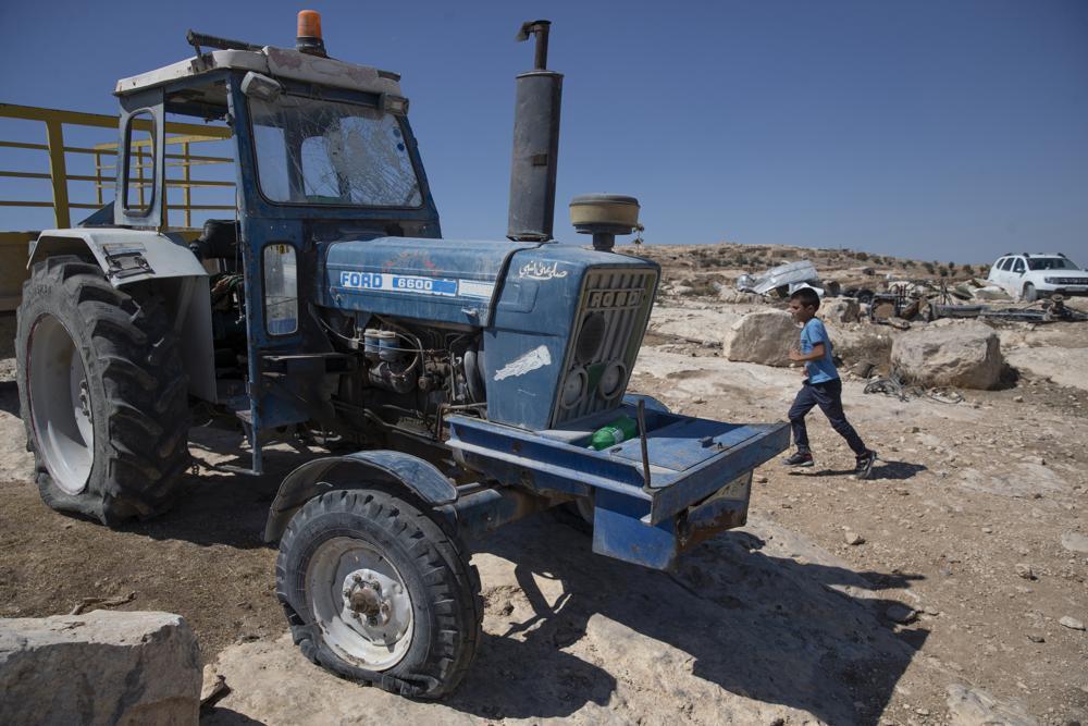 A tractor with a shattered windshield and flat tires following a settlers' attack from nearby settlement outposts on the Palestinian Bedouin community, in the West Bank village of al-Mufagara,