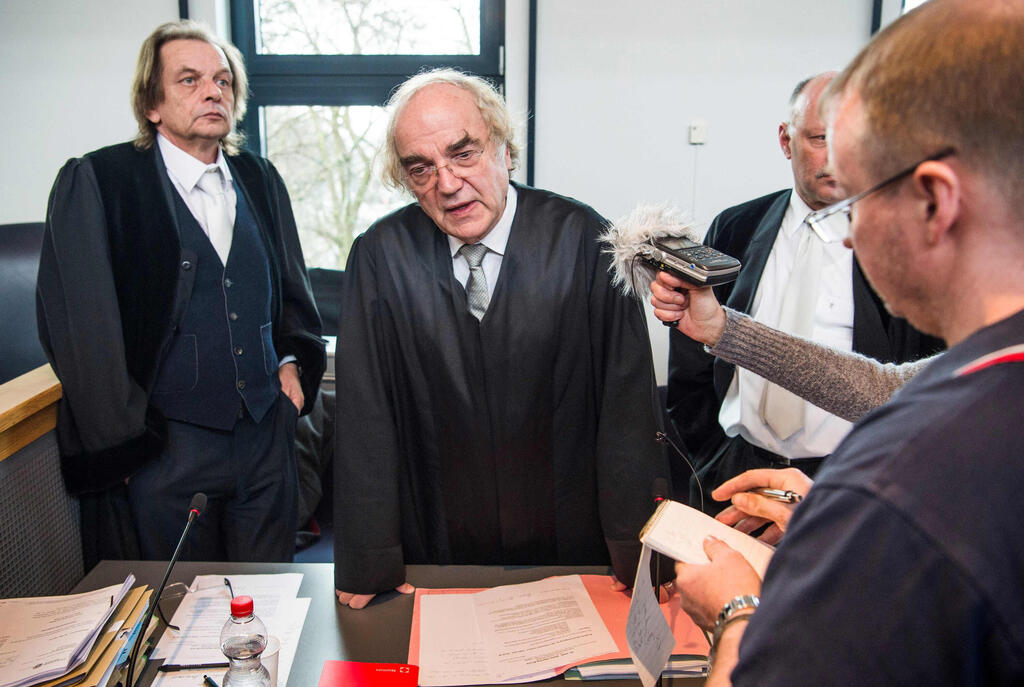 Prosecutor Thomas Walther, center, speaks to reporters on the first day of the trial against former SS medic Hubert Zafke, accused of aiding in 3,681 murders in Auschwitz in 1944, at the regional court of Neubrandenburg, February 29, 2016