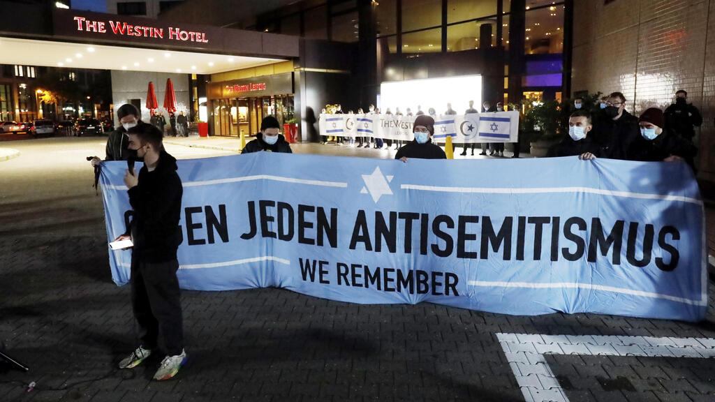 People gather in front of the 'Westin Hotel' in Leipzig, Germany, Tuesday, Oct. 5, 2021 to show solidarity with Jewish musician Gil Ofarim 