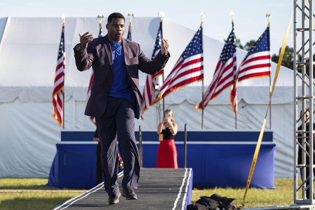 U.S. Senate candidate Herschel Walker takes the stage during former president Donald Trump's Save America rally in Perry, Ga., on Saturday, Sept. 25, 2021