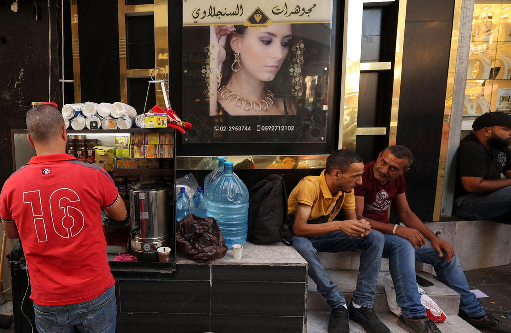 A Palestinian street vendor sells coffee in the West Bank city of Ramallah 