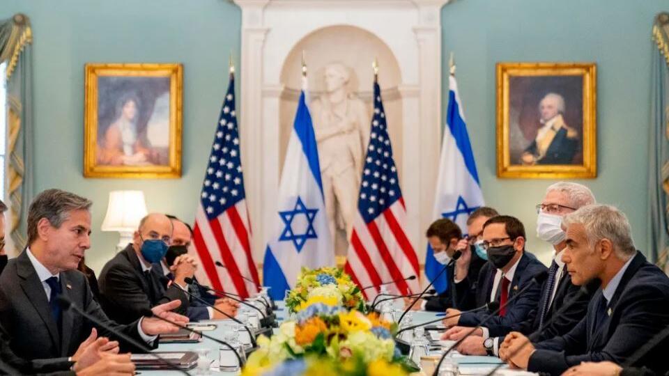 US Secretary of State Antony Blinken, left, accompanied by Israeli Foreign Minister Yair Lapid, right, speaks at bilateral meeting at the State Department in Washington, October 13