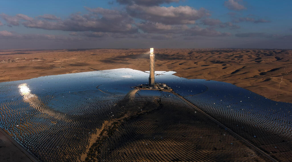 A view of a solar power tower in a solar farm near the Israeli kibbutz Ashalim in the Negev desert, southern Israel, October 23, 2021 