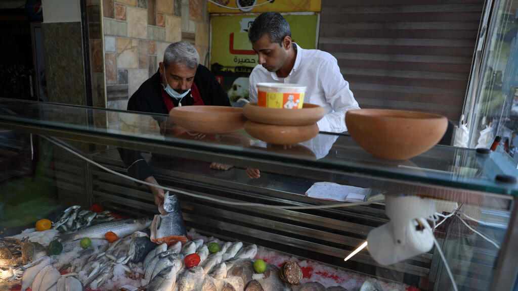 Moin and Mustapha Abu Hassira display Fresh fish