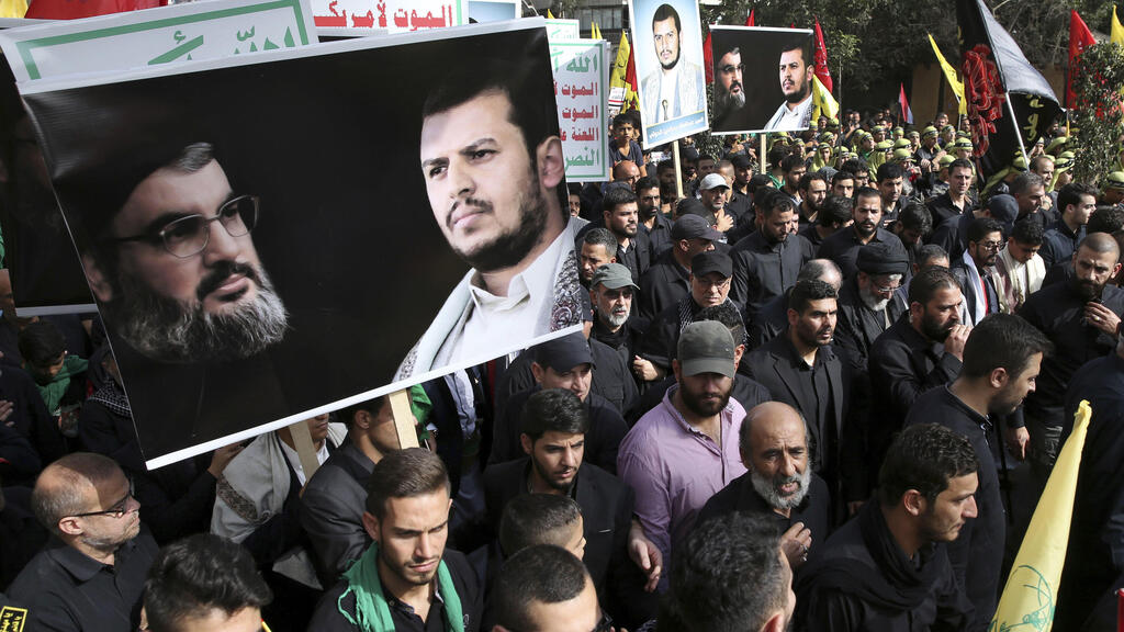Supporters of Iranian-backed Hezbollah hold portraits of Hassan Nasrallah and Abdul-Malik al-Houthi, the leader Beirut in  2016