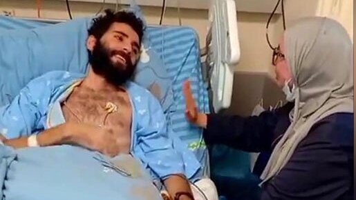 Alleged Hamas member and hunger-striking security prisoner Miqdad al-Qawasmi with his mother (Photo: Screen capture) Alleged Hamas member and hunger-striking security prisoner Miqdad Qawasmeh with his mother