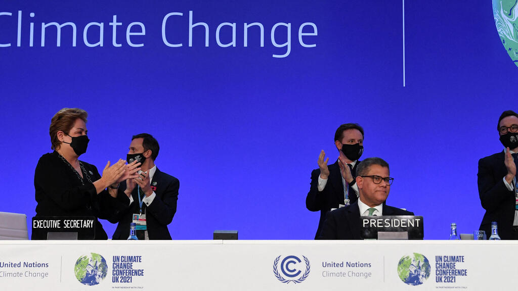 Britain's President for COP26 Alok Sharma is applauded after making his concluding remarks