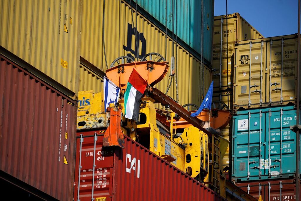 Containers carrying goods from the United Arab Emirates, which entered Israel on an MSC cargo ship, are unloaded with a cargo crane bearing Israeli and Emirati flags at Haifa's port, northern Israel 