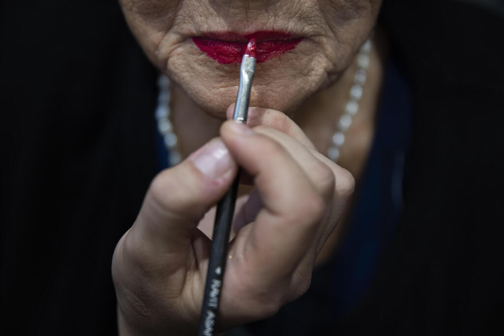 Holocaust survivor Rivka Papo, 87, gets make-up applied during a special beauty pageant honoring Holocaust survivors 