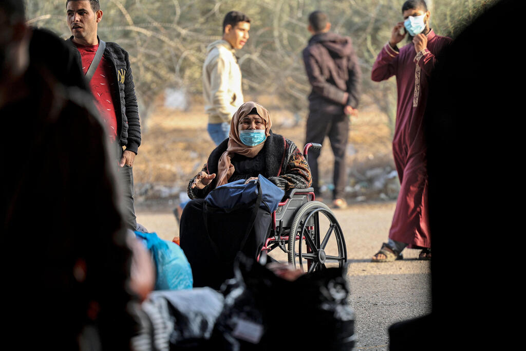 Palestinians wait their turn to cross into Egypt through the Rafah border crossing