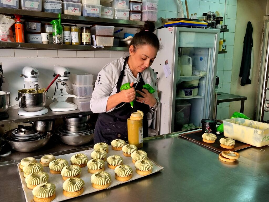 Keren Kadosh, co-owner of Café Kadosh, prepares pistachio-flavored pastries