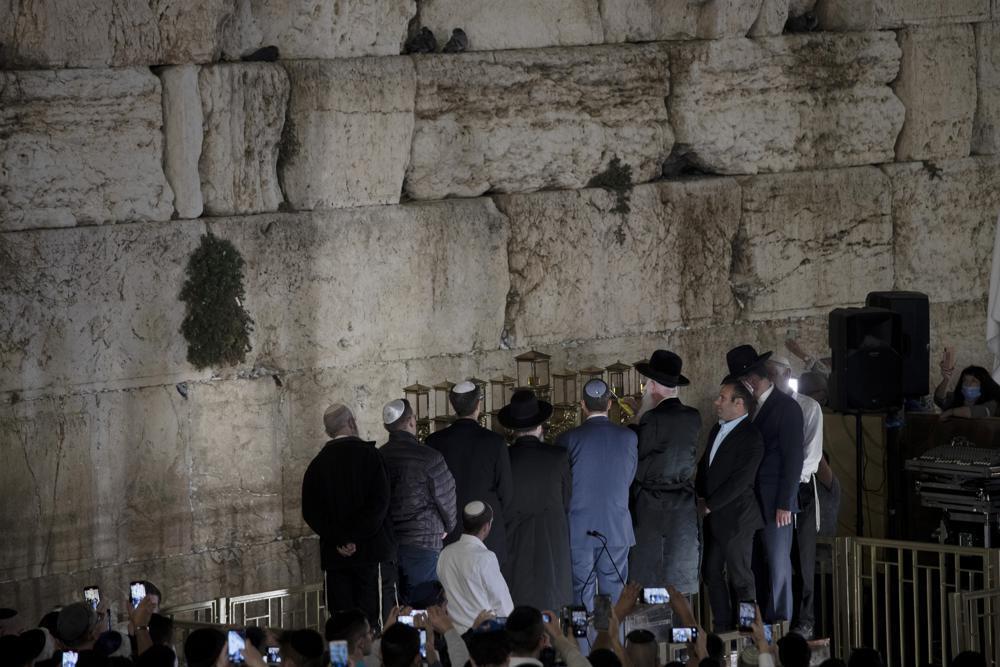 Dignitaries and religious leaders light the menorah on the third night of Hanukkah at the Western Wall 