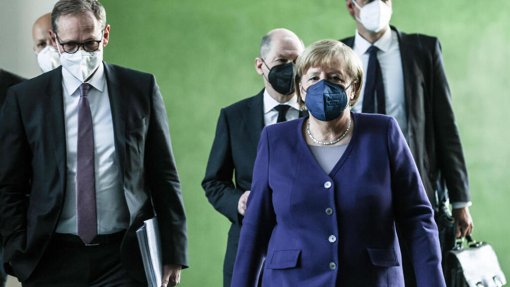 אנגלה מרקל אולף שולץ קנצלר קנצלרית גרמניה מסיבת עיתונאים הגבלות קורונה