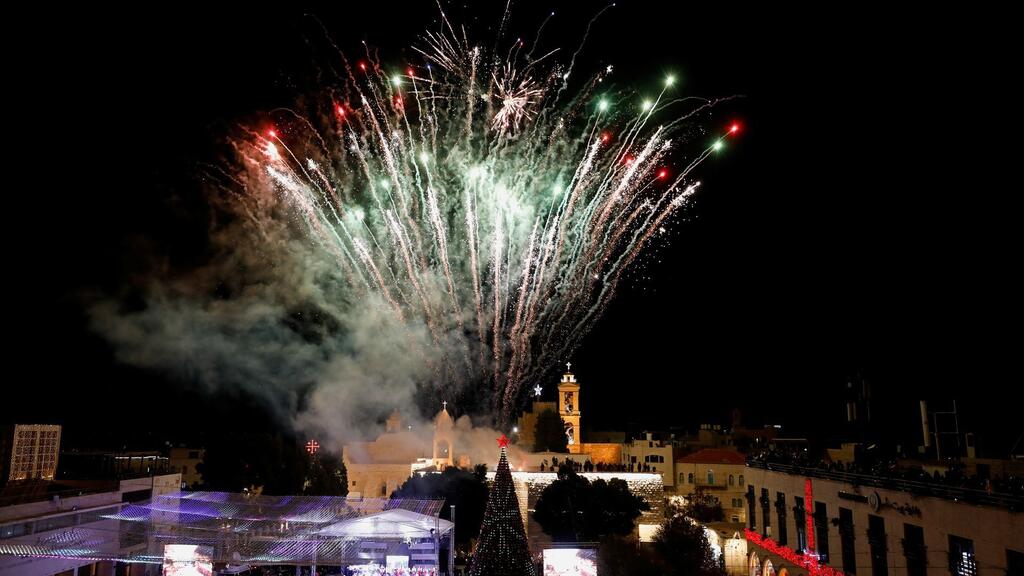 Fireworks are pictured as Palestinians light a Christmas tree at Manger Square outside the Church of the Nativity in Bethlehem