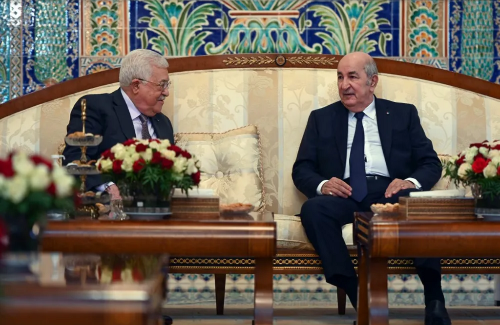 A handout picture provided by the Palestinian Authority's press office on December 5, 2021, shows Algeria's President Abdelmadjid Tebboune (R) and Palestinian leader Mahmoud Abbas in Algiers, Algeria