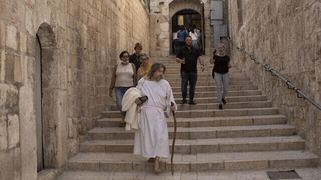 n American pilgrim walks to the Church of the Holy Sepulchre in the Old City of Jerusalem, 