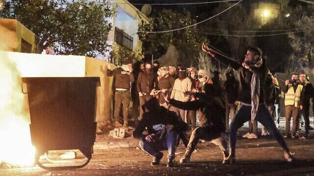 Palestinians clash with Israeli troops in the village of Burqa in the northern West Bank, on December 25, 2021.