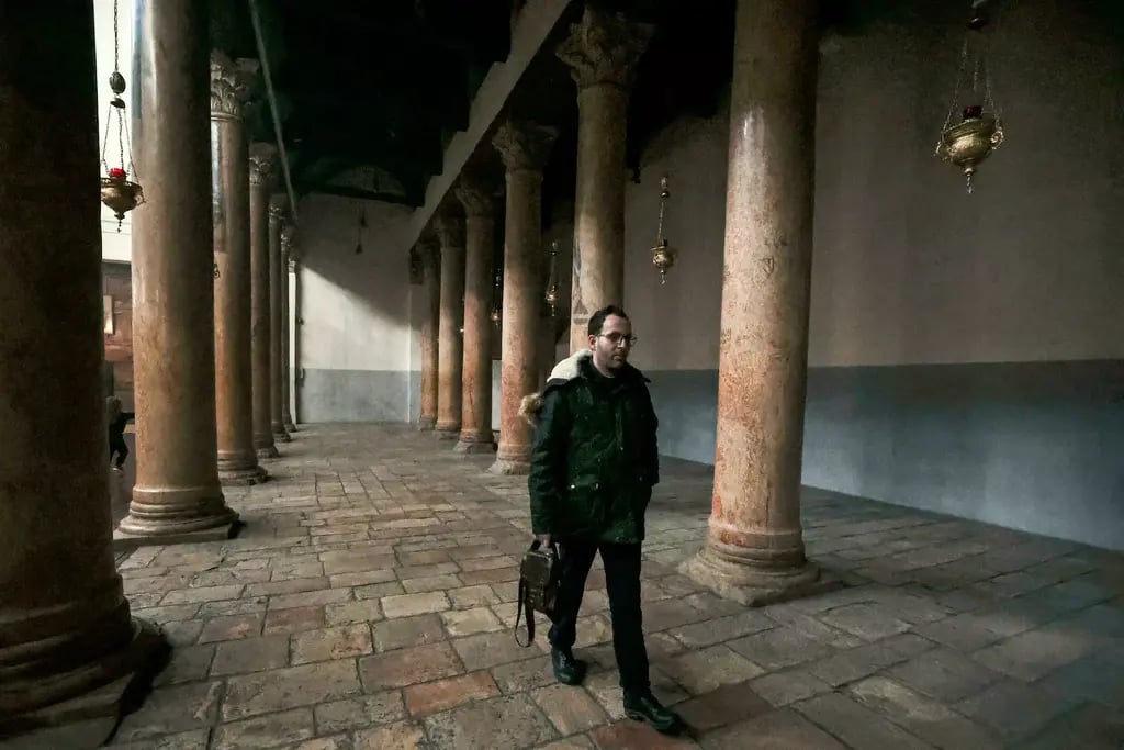 Ayyad walks along the colonnade at the Greek Basilica, the Church of the Nativity