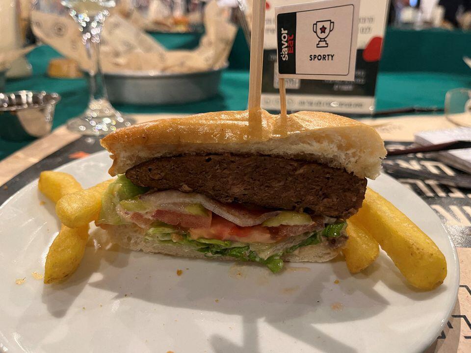 A plant-based hamburger, cooked by a robot developed by Israeli food-tech company SavorEat is served at a restaurant in Herzliya, Israel 