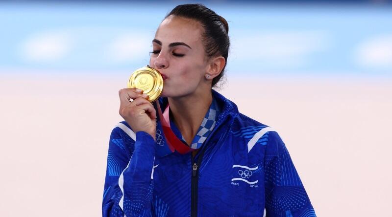 Linoy Ashram kisses her gold medal won in the 2020 Tokyo Olympics 