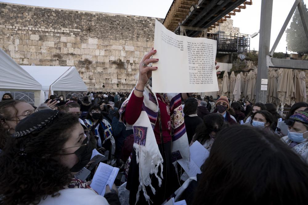 Members of Women of the Wall gather around a Torah scroll the group smuggled in for their Rosh Hodesh prayers marking the new month, at the Western Wall 