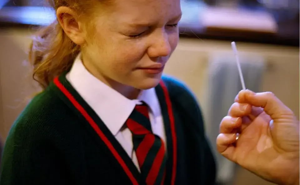  girl takes a COVID-19 lateral flow self test ahead of returning to school, amid the coronavirus disease (COVID-19) outbreak in Manchester, Britain,