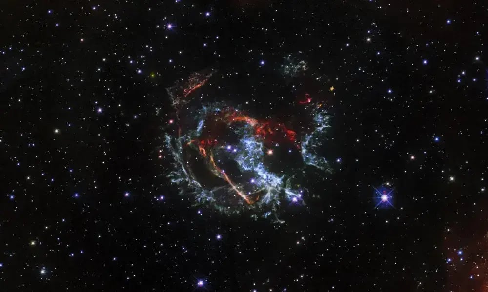 A Hubble image of an expanding, gaseous corpse — a supernova remnant — known as 1E 0102.2-7219