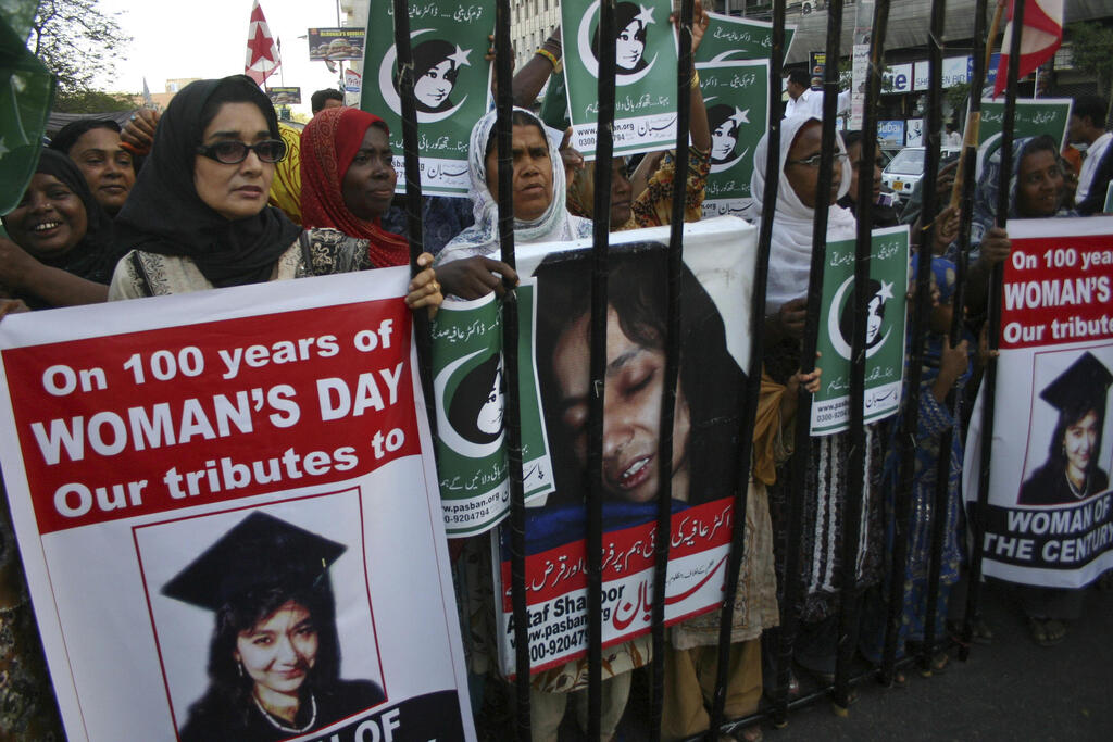 People rally demanding the release of Aafia Siddiqui, who was convicted in February 2010 of two counts of attempted murder, and who is currently being detained in the U.S. during International Women's Day in Karachi, Pakistan, Tuesday, March 8, 2011