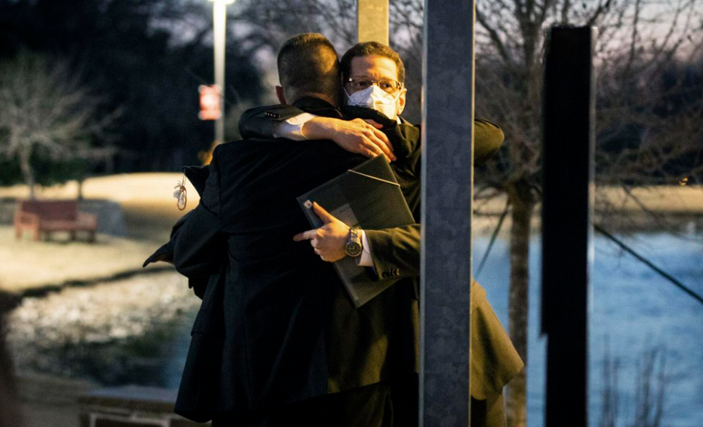 Congregation Beth Israel Rabbi Charlie Cytron-Walker, facing camera, hugs a man after a healing service at White's Chapel United Methodist Church in Southlake, Texas, January 17, 20222