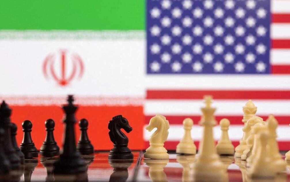Chess pieces are seen in front of displayed Iran's and U.S. flags 
