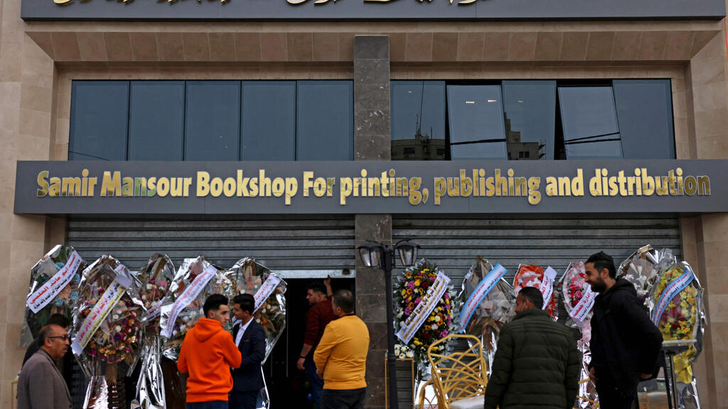 Workers prepare for the opening of the new Samir Mansour bookshop in Gaza 