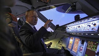 נשיא רוסיה ולדימיר פוטין בוחן סימולטור טיסה במהלך ביקור במרכז ההכשרה של חברת אירופלוט, מרץ 2022