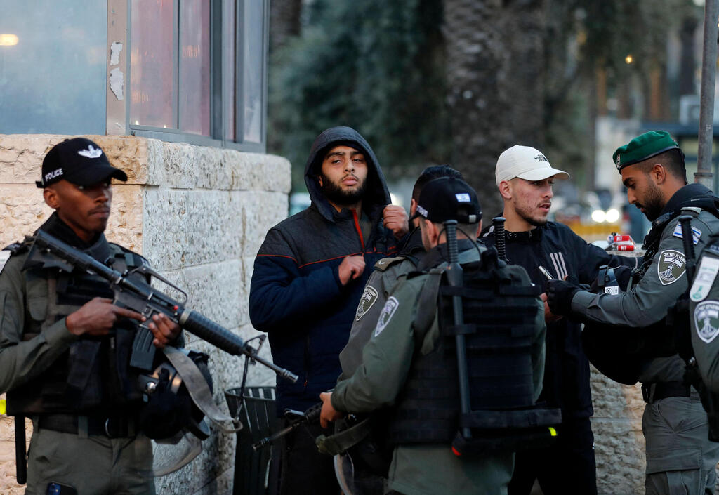 Israeli security forces check the IDs of Palestinian youth outside Damascus' Gate in Jerusalem