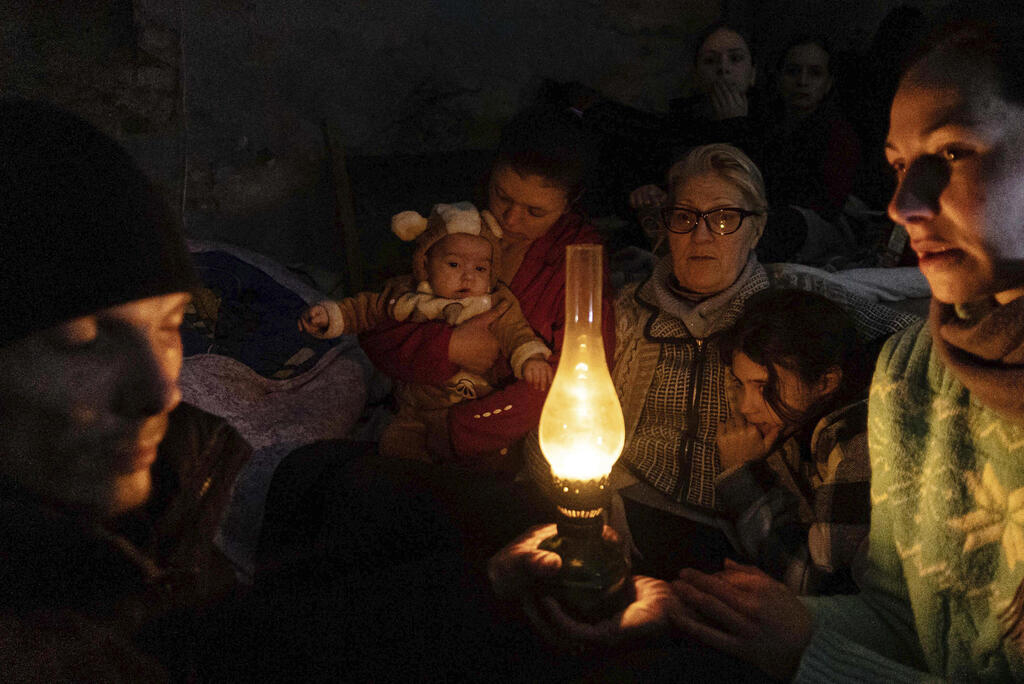 People sit in a shelter amid Russian attacks in Mariupol 