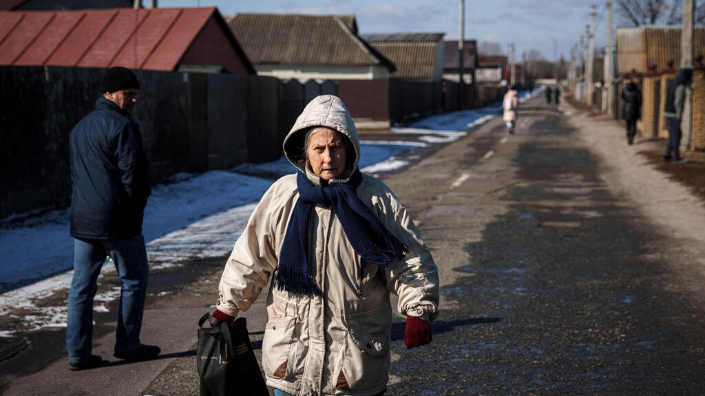 A woman walks down the street in a village in east Ukraine 