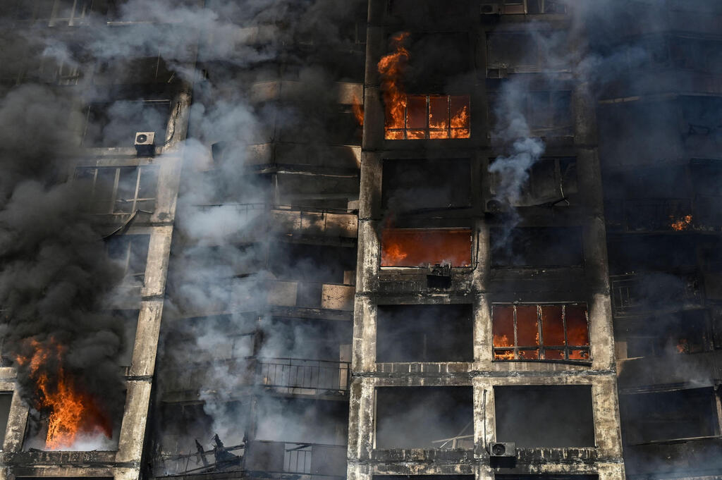 A Kyiv apartment building on fire after being hit by Russian shelling on Tuesday 