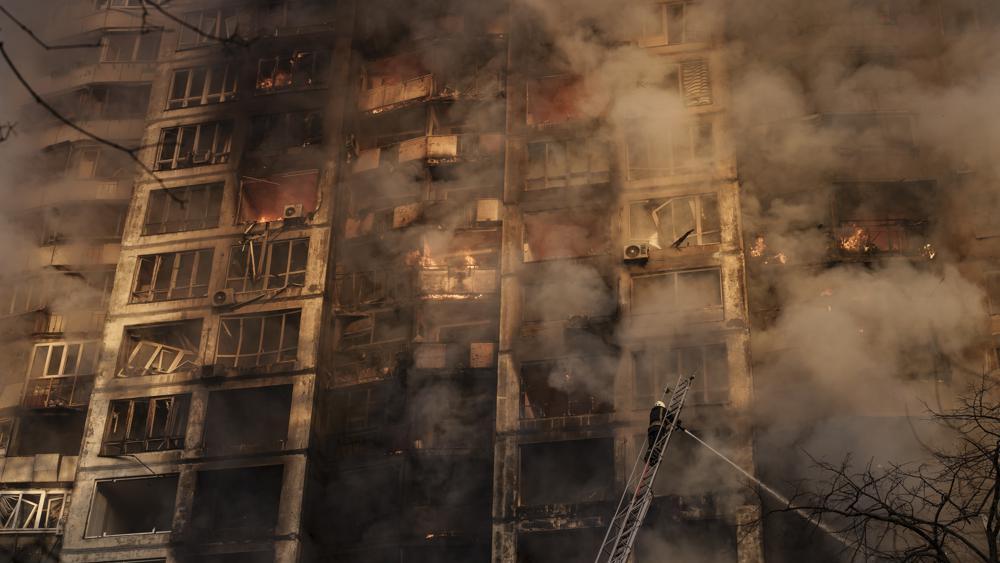 Firefighters extinguish fires in an apartment building after being hit by shelling in Kyiv