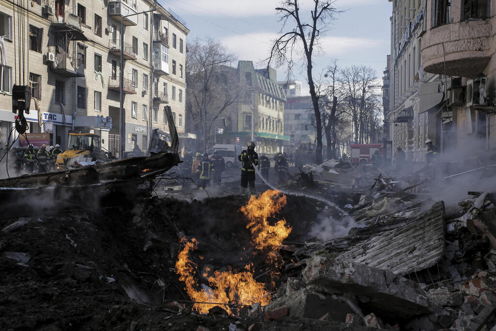 Fire fighters at site of shelling in Kharkiv on Monday 